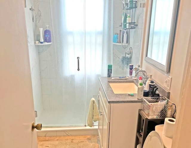 bathroom featuring vanity, tile patterned floors, and a shower with door