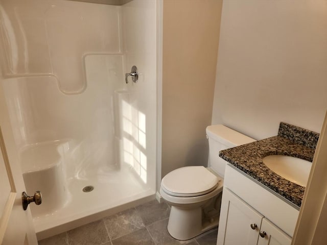 bathroom with vanity, toilet, and walk in shower