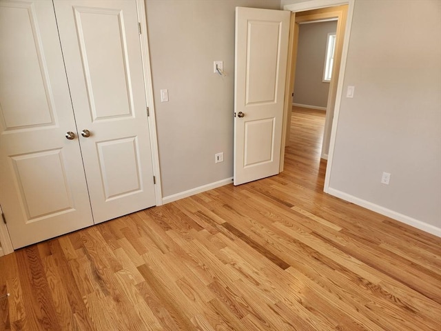 unfurnished bedroom featuring baseboards and light wood-style floors