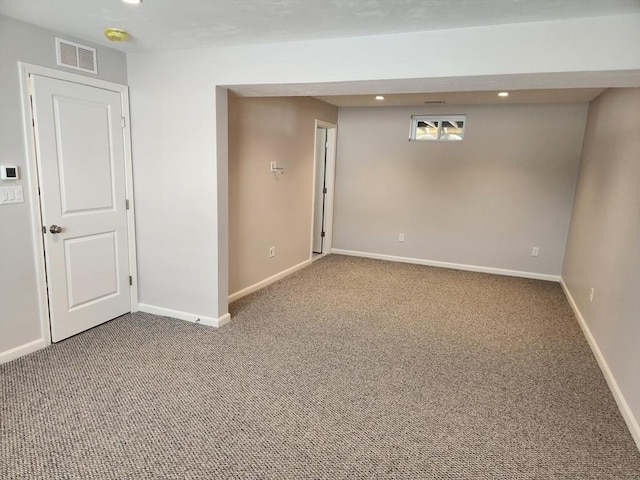 spare room with carpet, visible vents, baseboards, and recessed lighting