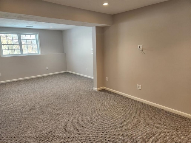 empty room featuring baseboards, dark colored carpet, and recessed lighting