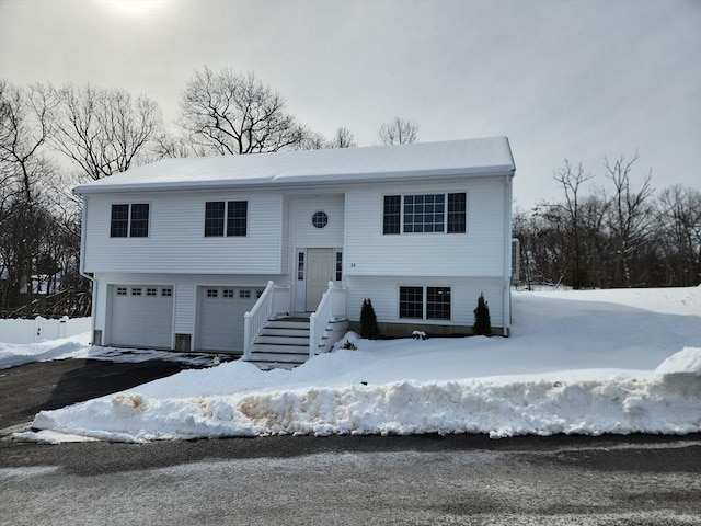 split foyer home with driveway and an attached garage