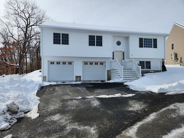 split foyer home with aphalt driveway and an attached garage