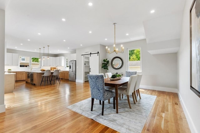 66 Upham St, Newton, MA 02465 - dining room featuring a barn door, healthy amount of natural light, light wood finished floors, and recessed lighting