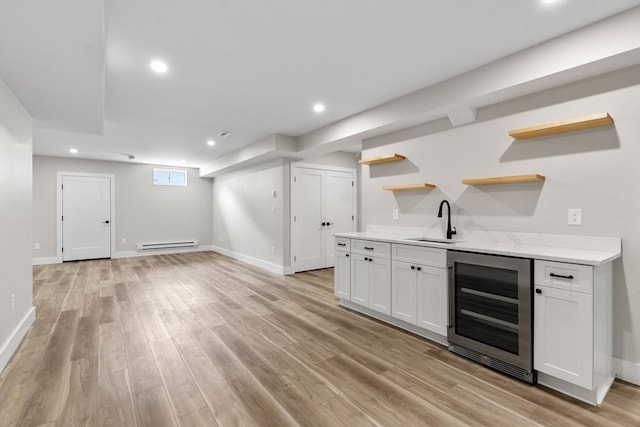 66 Upham St, Newton, MA 02465 - indoor bar featuring beverage cooler, baseboard heating, light wood-style floors, baseboards, and recessed lighting