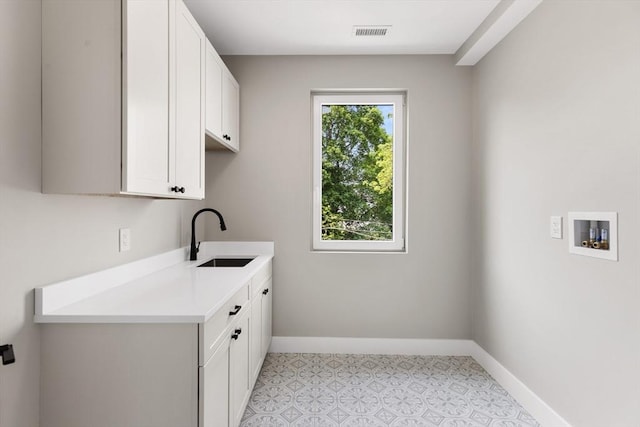 66 Upham St, Newton, MA 02465 - washroom featuring cabinet space, baseboards, and washer hookup