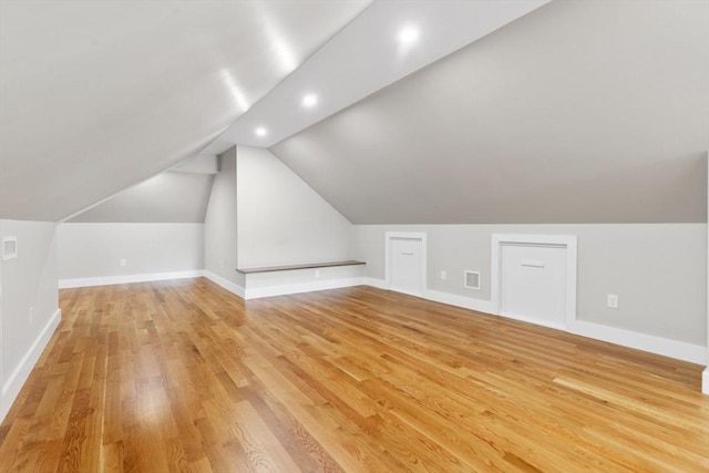 66 Upham St, Newton, MA 02465 - additional living space featuring light wood finished floors, baseboards, vaulted ceiling, and recessed lighting