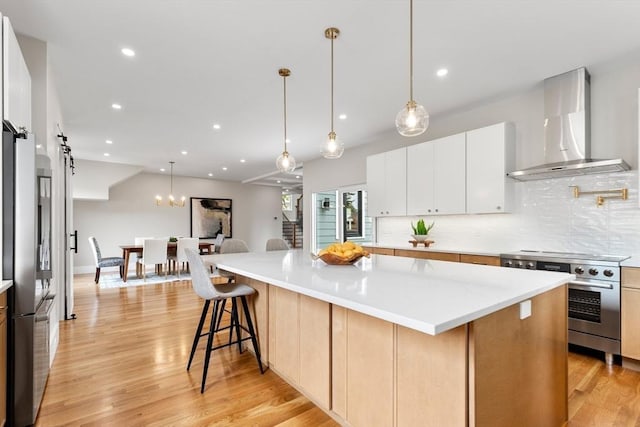 66 Upham St, Newton, MA 02465 - kitchen with wall chimney exhaust hood, stainless steel appliances, backsplash, light wood-type flooring, and a spacious island