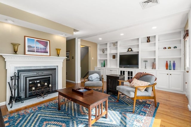17 Angela Ln Unit 17, Watertown, MA 02472 - living area featuring light wood-style flooring, a premium fireplace, baseboards, recessed lighting, and built in features