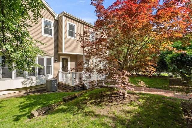 17 Angela Ln Unit 17, Watertown, MA 02472 - back of house featuring central AC unit, a deck, and a yard