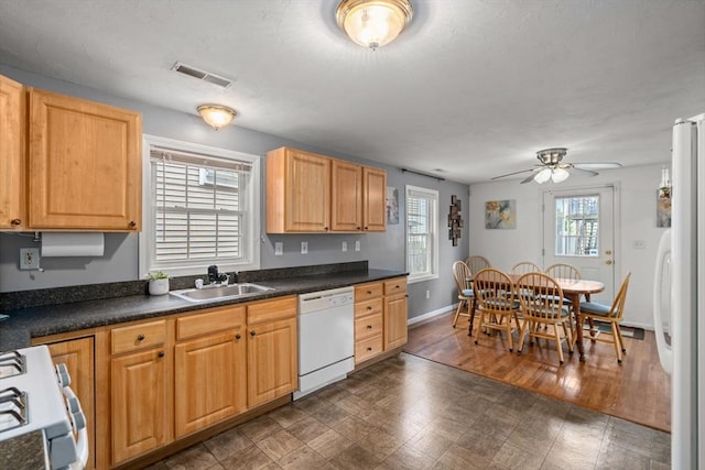 55 W 3rd St Unit 3, Lowell, MA 01850 - kitchen featuring white appliances, a sink, a ceiling fan, dark countertops, and baseboards