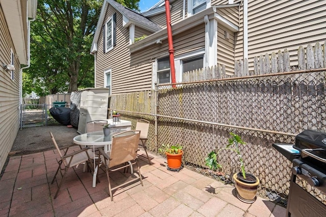 55 W 3rd St Unit 3, Lowell, MA 01850 - fenced backyard with a patio area, outdoor dining area, and area for grilling