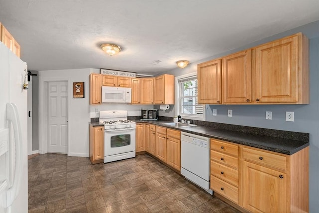 55 W 3rd St Unit 3, Lowell, MA 01850 - kitchen with white appliances, a sink, dark countertops, baseboards, and light brown cabinetry