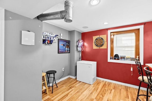 laundry area with wood-type flooring