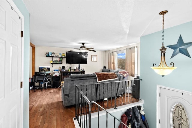 living room with ceiling fan and wood-type flooring