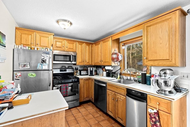 kitchen featuring light tile patterned flooring, stainless steel appliances, and sink