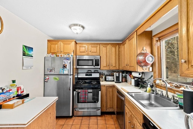 kitchen with sink, stainless steel appliances, and light tile patterned flooring