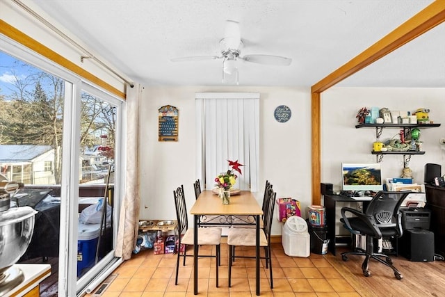 tiled dining room featuring ceiling fan