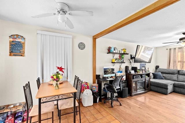 dining space featuring ceiling fan and light wood-type flooring