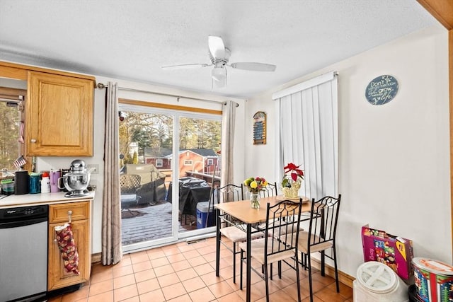 dining space featuring light tile patterned floors, a textured ceiling, and ceiling fan