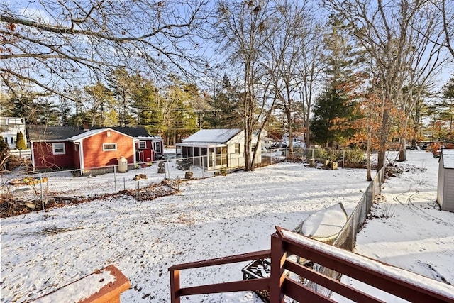 yard layered in snow with an outbuilding