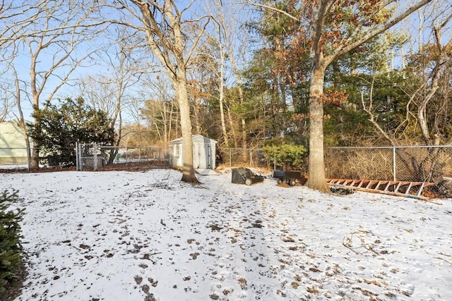 snowy yard with a shed