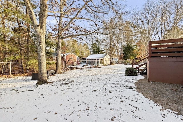 yard covered in snow featuring an outdoor structure