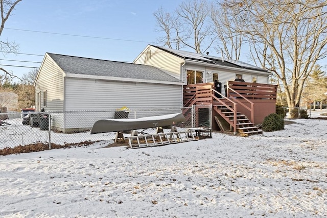 snow covered property featuring a wooden deck