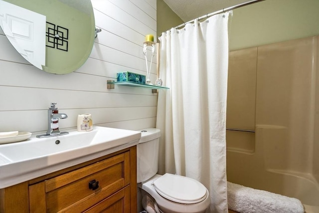 bathroom with a shower with shower curtain, toilet, and vanity