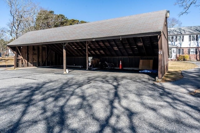 exterior space featuring aphalt driveway and a detached carport