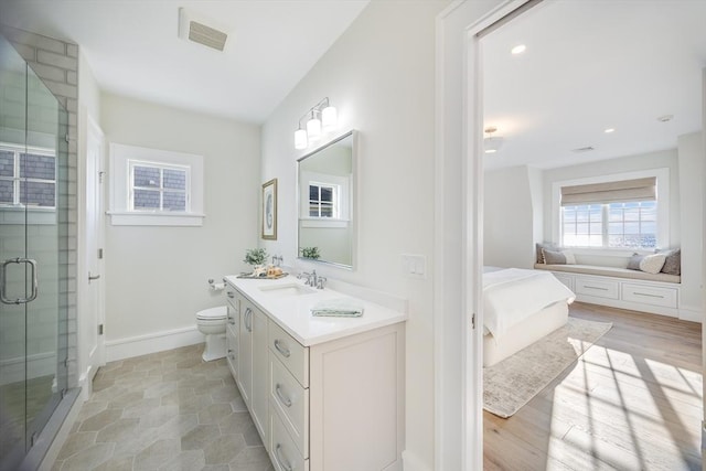 bathroom featuring toilet, vanity, walk in shower, and hardwood / wood-style floors