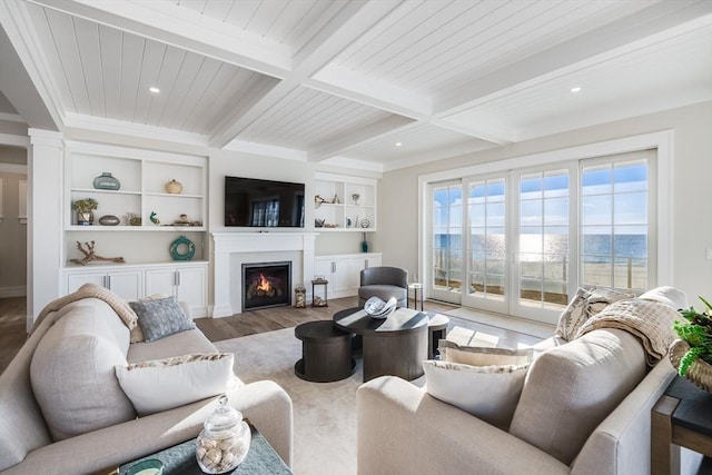 living room featuring beam ceiling, built in shelves, coffered ceiling, and hardwood / wood-style floors