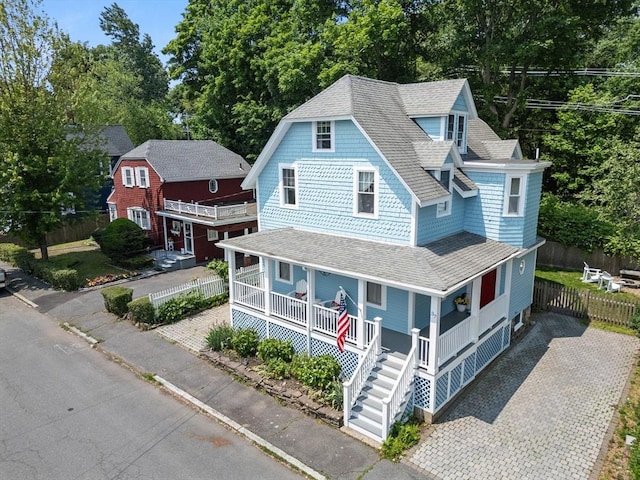 37 Devereux St, Marblehead, MA 01945 - view of front of property with covered porch, a shingled roof, view of wooded area, and stairway