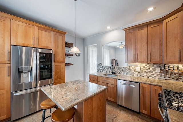 37 Devereux St, Marblehead, MA 01945 - kitchen featuring stainless steel appliances, decorative backsplash, a breakfast bar, light stone countertops, and a kitchen island