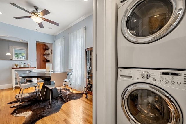 37 Devereux St, Marblehead, MA 01945 - laundry room featuring stacked washer / drying machine, a ceiling fan, wood finished floors, and crown molding