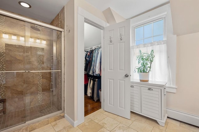 37 Devereux St, Marblehead, MA 01945 - bathroom with a baseboard heating unit, a shower stall, a spacious closet, and tile patterned floors
