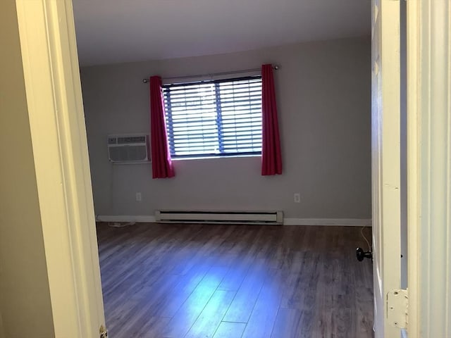 unfurnished room featuring a baseboard heating unit, hardwood / wood-style flooring, and a wall unit AC