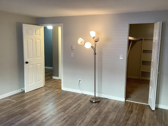 unfurnished bedroom featuring dark wood-type flooring and a closet