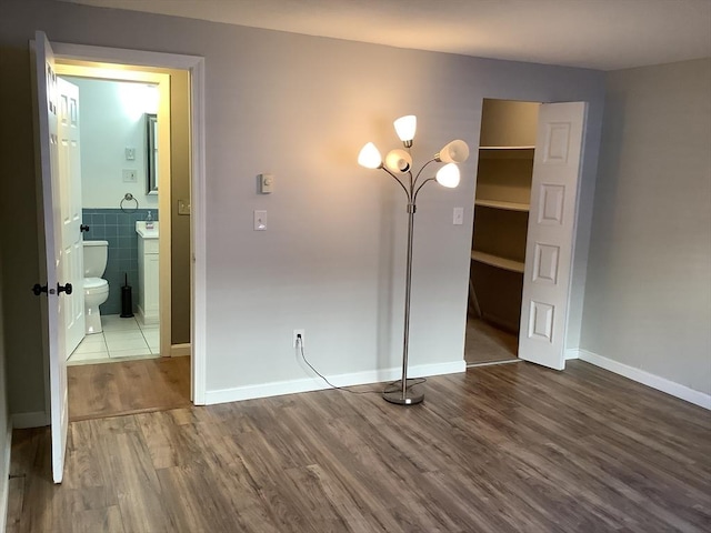 interior space featuring tile walls and hardwood / wood-style flooring