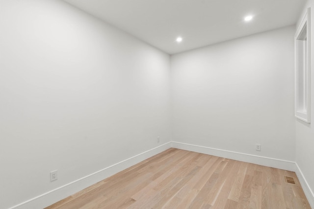 spare room with light wood-type flooring, visible vents, baseboards, and recessed lighting