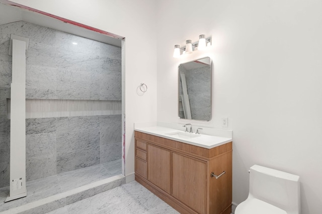 bathroom featuring toilet, a shower, and vanity