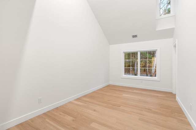 empty room featuring light wood-style flooring, visible vents, and baseboards