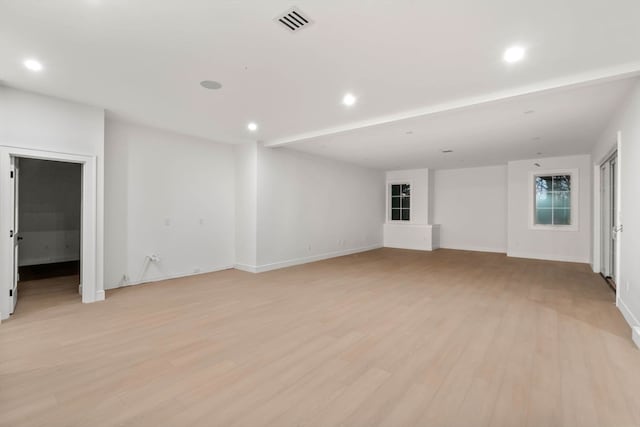 unfurnished living room featuring light wood-type flooring, baseboards, visible vents, and recessed lighting