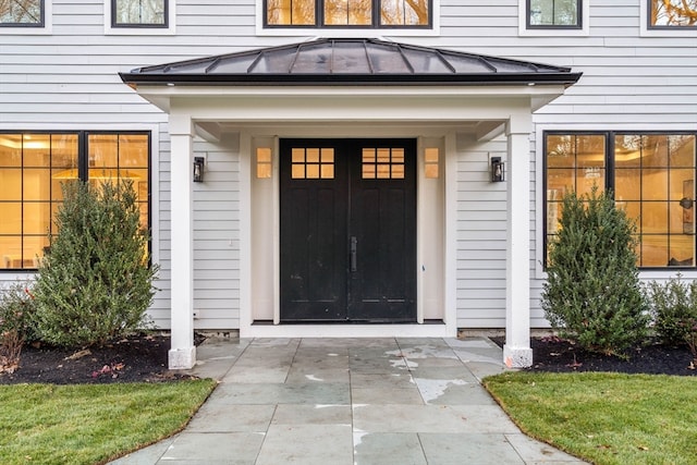 property entrance featuring a standing seam roof and metal roof