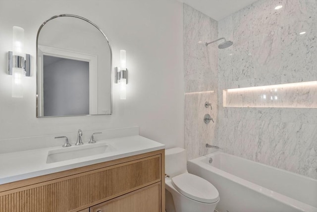 bathroom with tub / shower combination, vanity, and toilet