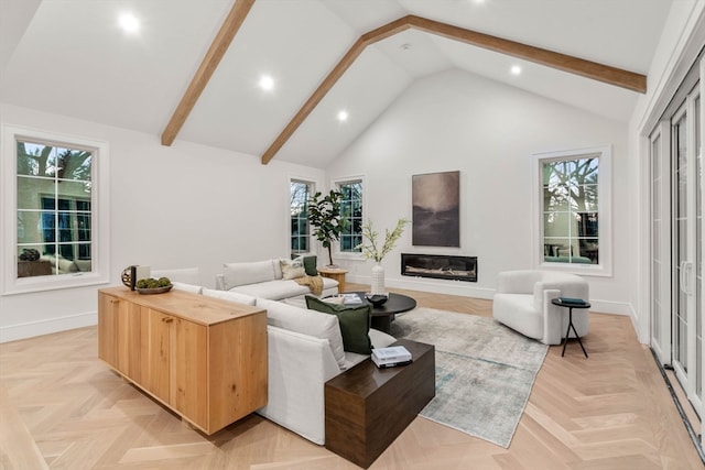 living room featuring high vaulted ceiling, beamed ceiling, a glass covered fireplace, and a wealth of natural light