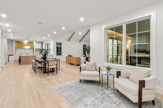 dining space featuring lofted ceiling, recessed lighting, and light wood-style floors