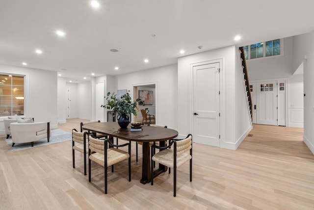 dining area with light wood finished floors, baseboards, and recessed lighting