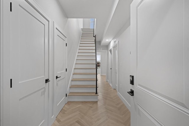 stairway featuring baseboards and recessed lighting