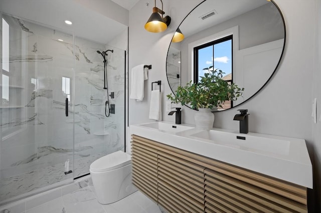 full bath with toilet, a marble finish shower, marble look tiles, double vanity, and recessed lighting